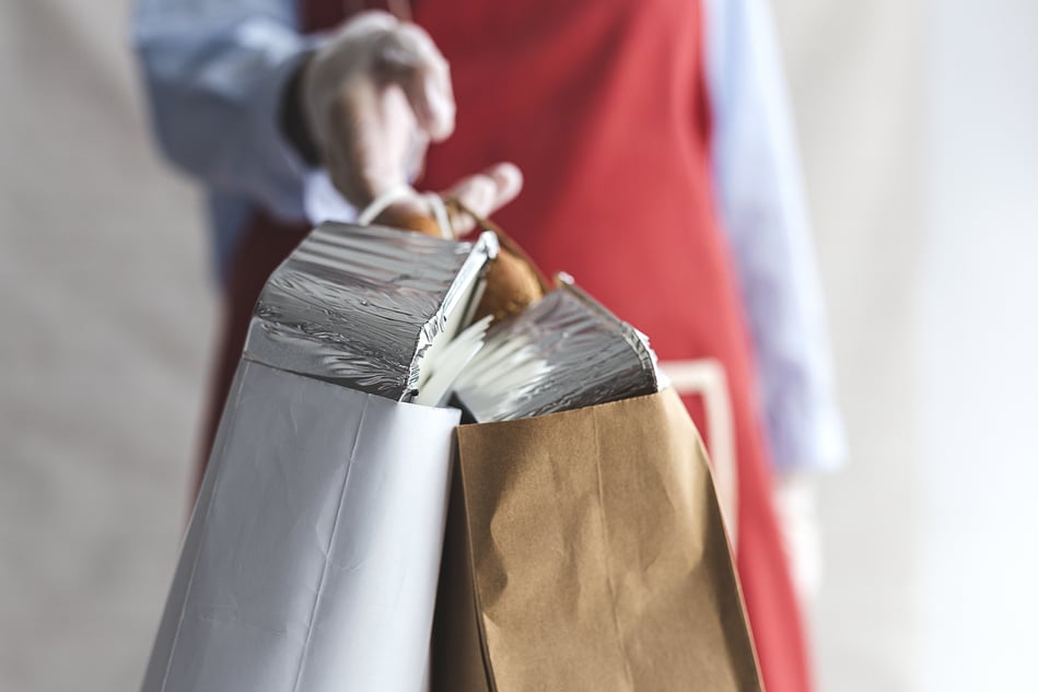 Person Holding Paper Bags with Takeaway Food